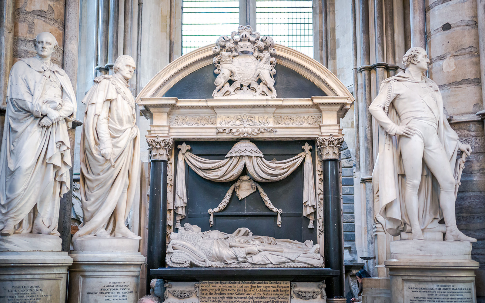 Westminster Abbey interior with visitors exploring Poet's Corner, London.